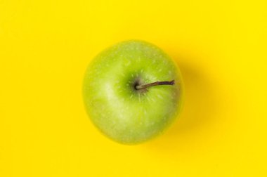 Sarı arka planda izole yeşil elma