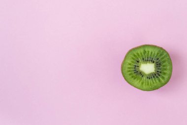 Pembe bir arka plan üzerinde Dilimlenmiş Kivi. Sarı bir arka plan üzerinde kivi. Bir dilimlenmiş parça.