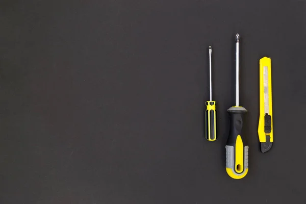 DIY tool kit. Tools lie on a black background. There is a place for text.