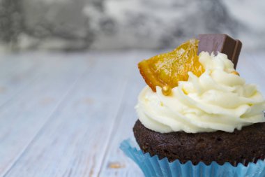 Vanilya tereyağı frosting ve altın kırıntıları, çikolata ve limon ile Çikolata cupcakes. Metin için bir not var.