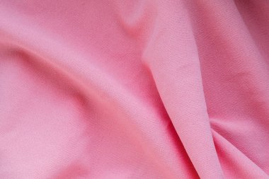 Tekstil ve doku kavramları. Pembe dalgalı arka plan kumaş closeup. üst görünüm.