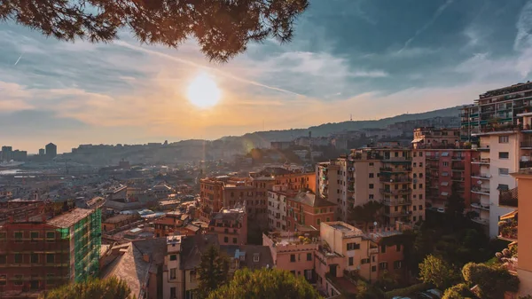 View of houses on hills under sunset in Genoa, Italy