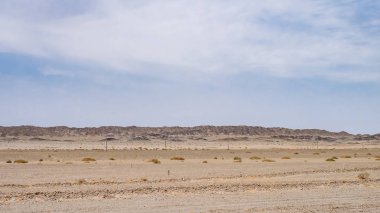 Dağlar yakınındaki Dunhuang, Kuzeybatı Çin'deki gobi çölünde görünümünü