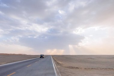 Dunhuang Yardang Ulusal Geopark, Gansu, Çin'deki gobi Çölü ortasında yolda seyahat araba