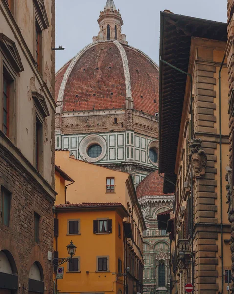 View of the dome of the Florence Cathedral between buildings of the historical center of Florence, Italy