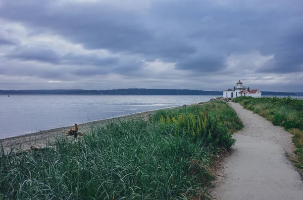 Path leading to the Victorian-era lighthouse in Discovery Park of Seattle, USA