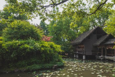 Traditional Chinese architecture by water in Shenyuan (Shen Garden) scenic area in Shaoxing, China clipart