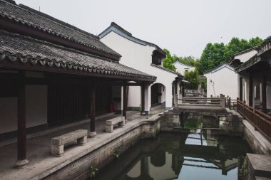 Traditional Chinese architecture by canal in Lanting (Orchid Pavilion) scenic area in Shaoxing, China clipart
