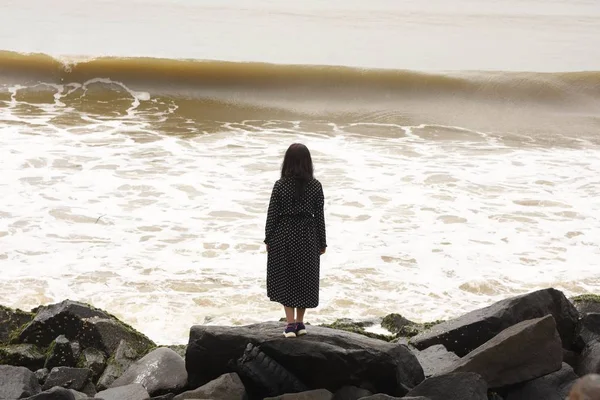 Girl enjoying the wave sound and watching the sea Royalty Free Stock Images