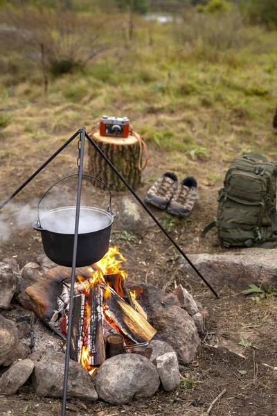 Cooking on a fire. Fish soup on a fire. Food in a cauldron on a fire. Food outdoors. Cooking outdoors. Cooking in nature on the cauldron.