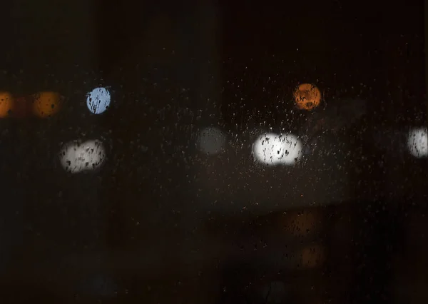 Raindrops on the night window.
