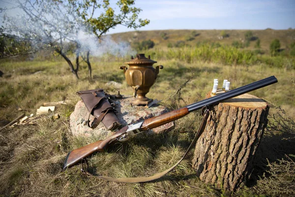 Hunting rifle. Gun near the stump.