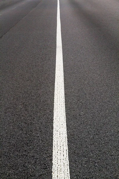 Highway. Road marking. The road near the forest. The road goes t