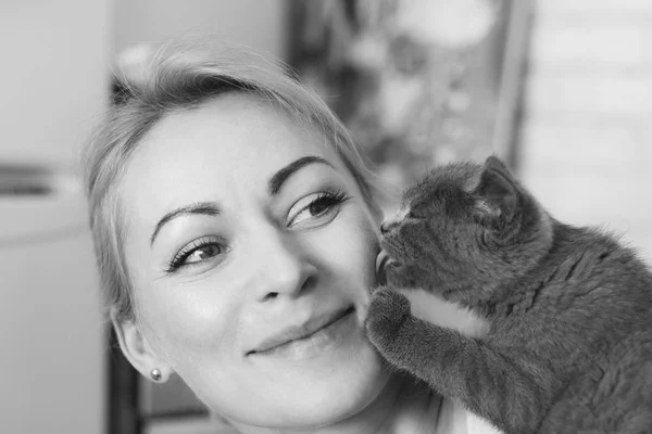 Woman with a cat. Cat licks the cheek of a woman. Cat — Stock Photo, Image