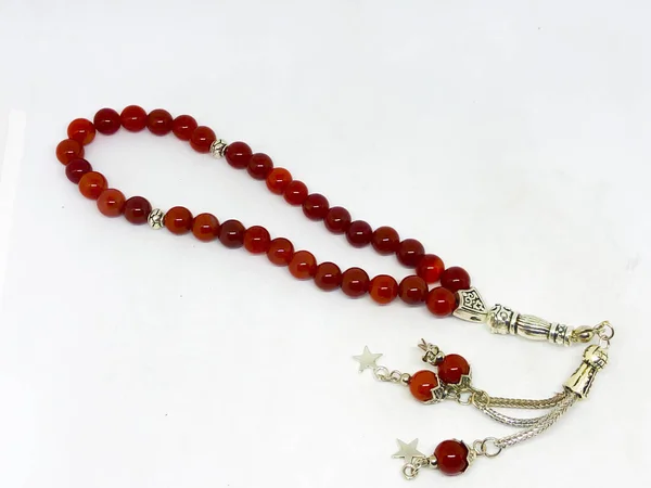 Various rosary beads, white background