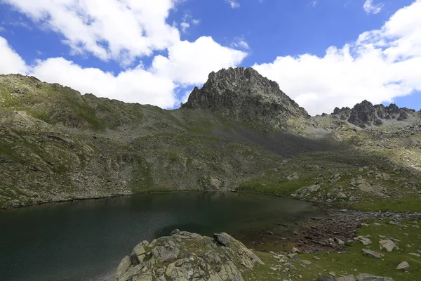 Foggy Kackar mountains reflected in the glacier lake