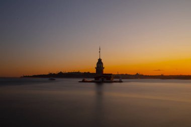 İstanbul, Türkiye 'nin sembolü Leander' s Tower olarak da bilinen ünlü Maiden 's Tower (Kiz Kulesi) ile Boğaz' ın üzerinde kızgın bir günbatımı. Duvar kağıdı veya rehber kitap için sahne yolculuğu arkaplanı