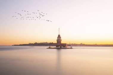 İstanbul, Türkiye 'nin sembolü Leander' s Tower olarak da bilinen ünlü Maiden 's Tower (Kiz Kulesi) ile Boğaz' ın üzerinde kızgın bir günbatımı. Duvar kağıdı veya rehber kitap için sahne yolculuğu arkaplanı