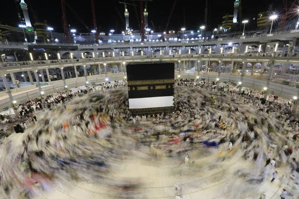 Dünyanın dört bir yanından gelen Müslüman hacılar, Suudi Arabistan'da Hac sırasında geceleri Kabe'yi geziyor. Hareket bulanıklığı yakalamak için uzun süre maruz kaldı.