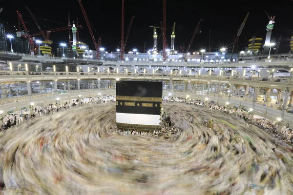 Dünyanın dört bir yanından gelen Müslüman hacılar, Suudi Arabistan'da Hac sırasında geceleri Kabe'yi geziyor. Hareket bulanıklığı yakalamak için uzun süre maruz kaldı.