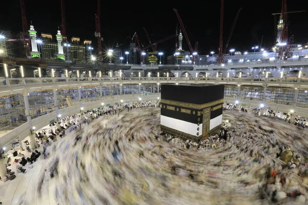 Dünyanın dört bir yanından gelen Müslüman hacılar, Suudi Arabistan'da Hac sırasında geceleri Kabe'yi geziyor. Hareket bulanıklığı yakalamak için uzun süre maruz kaldı.