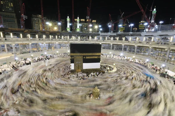Dünyanın dört bir yanından gelen Müslüman hacılar, Suudi Arabistan'da Hac sırasında geceleri Kabe'yi geziyor. Hareket bulanıklığı yakalamak için uzun süre maruz kaldı.