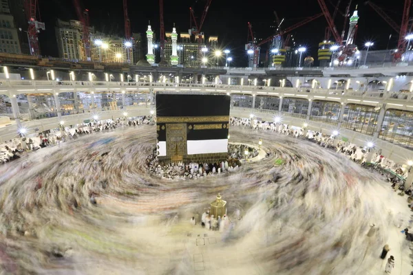 Dünyanın dört bir yanından gelen Müslüman hacılar, Suudi Arabistan'da Hac sırasında geceleri Kabe'yi geziyor. Hareket bulanıklığı yakalamak için uzun süre maruz kaldı.