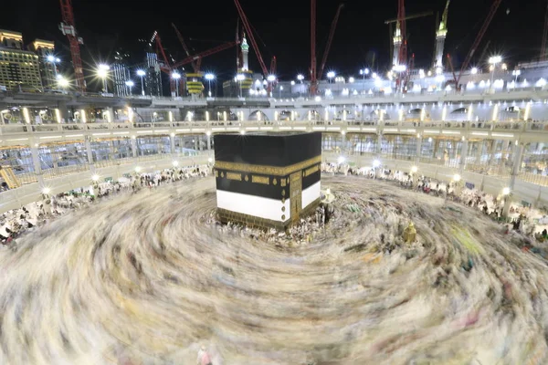 Dünyanın dört bir yanından gelen Müslüman hacılar, Suudi Arabistan'da Hac sırasında geceleri Kabe'yi geziyor. Hareket bulanıklığı yakalamak için uzun süre maruz kaldı.