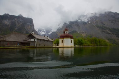 Yazın güneşli bir günde dünyaca ünlü Sankt Bartholomae hac kilisesi ve Watzmann Dağı ile Konigssee Gölü 'nün klasik panoramik manzarası, Berchtesgadener Toprakları, Bavyera, Almanya