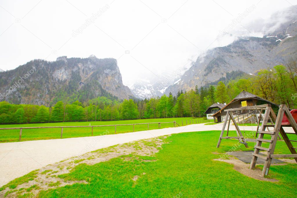 Classic panoramic view of Lake Konigssee with world famous Sankt Bartholomae pilgrimage church and Watzmann mountain on a beautiful sunny day in summer, Berchtesgadener Land, Bavaria, Germany