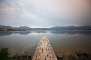 Bavyera Alpleri'ndeki Hopfensee Gölü'ne giden uzun ahşap iskele