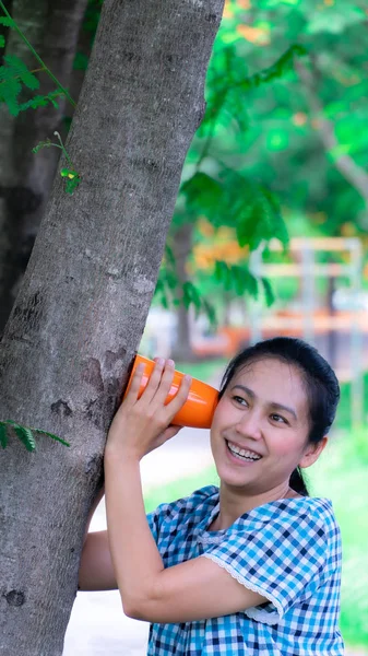 Ásia mulheres ouvindo mensagem da árvore — Fotografia de Stock