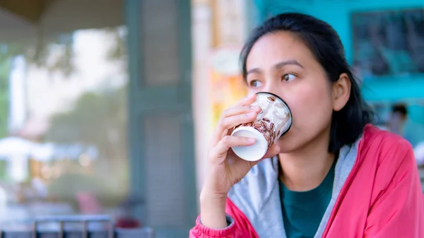Portrait of Asia women drinking hot coffee