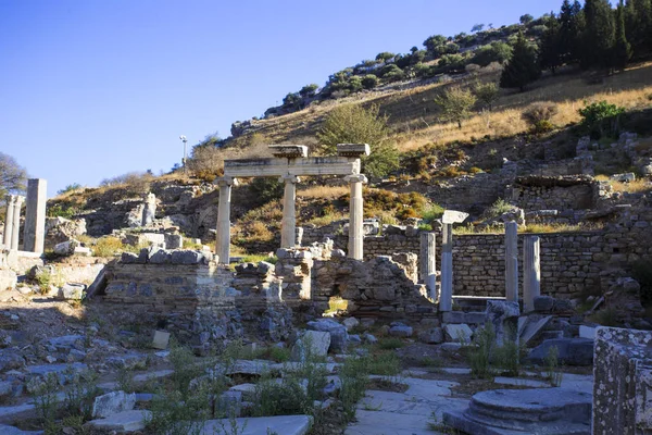 View of the ruins of the ancient Roman city of Ephesus with ancient columns.