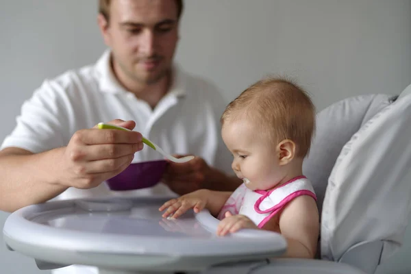 Father Feeding Baby Daughter Spoon High Chair — Stock Photo, Image