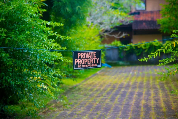 PRIVATE PROPERTY Sign nearby the Beach of the Bali island, Indonesia. Bali is an Indonesian island and known as a tourist destination. In Bali, rice harvest seasons come three times in a year.