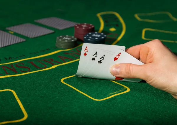 Winning combination in poker game. Cards and chips on a green cloth
