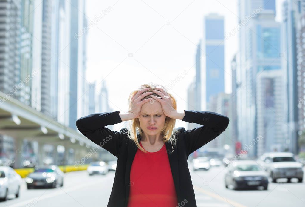 Stressed business woman in the busy city