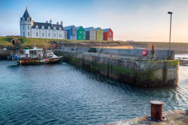 Fishing boats in the harbour at Jon O Groats in Scotland clipart