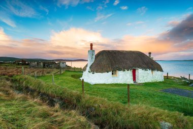 A pretty thatched cottagemat Malaclate on North Uist in the Western Isles of Scotland clipart