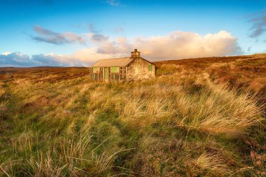 A shieling or shepherds hut on peat moorland near Stornoway on the Isle of Lewis in the Outer Hebrides clipart