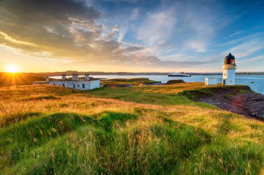 Stunning sunset over Arnish Point and it's lighthouse overlooking Stornoway harbour on the Isle of Lewis in the Outer Hebrides of Scotland clipart
