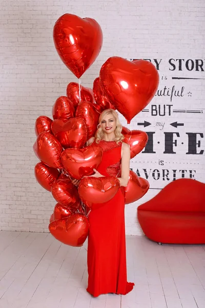 Beautiful woman with red balloon heart shape for valentine\'s day