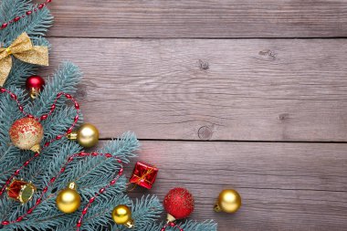 Noel dekorasyonu. Köknar ağacı dalı topları, hediyeler ve gri arka plan üzerinde yay. Noel kompozisyon