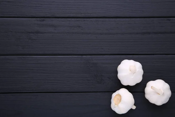 Fresh garlic on a black background. Garlic on black wooden table