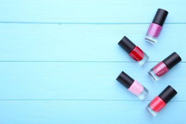 Grup mavi ahşap zemin üzerine parlak tırnak cilaları