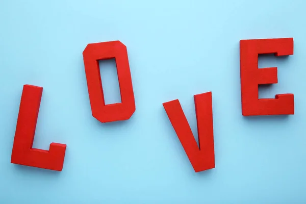 Red letters love on blue background. LOVE word on blue.