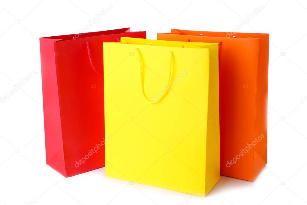 Colourful paper shopping bags isolated on white, cut out