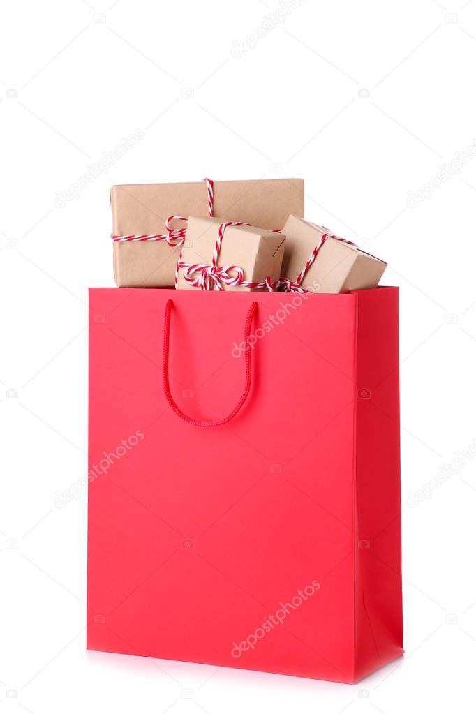 Gift boxes in red shoping bag on white background, shopping concept