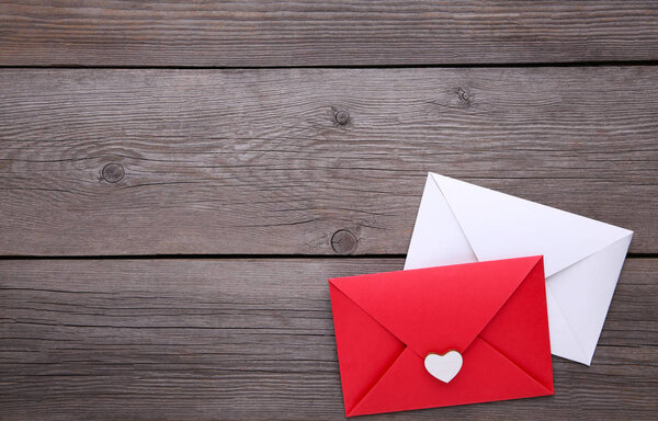 Red and white envelopes with heart on grey background
